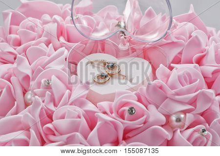Earrings gold with Topaz stones in a gift box of pink roses