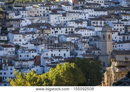 Alcala del Jucar Spain - October 29 2016: Panoramic view of typical houses of city during autumn to the right church of San Andres take in Alcala of the Jucar Albacete province Spain