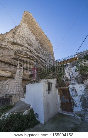 Alcala del Jucar Spain - October 29 2016: typical house of La Mancha placed in the skirts of the castle on top of limestone mountain is situated Castle of the 12TH century Almohad origin take in Alcala del Jucar Albacete province Spain
