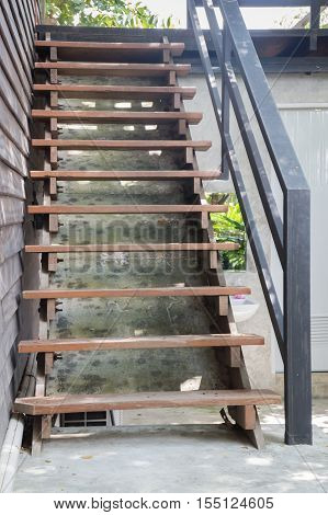 Exterior brown wooden staircase with iron banister stock photo