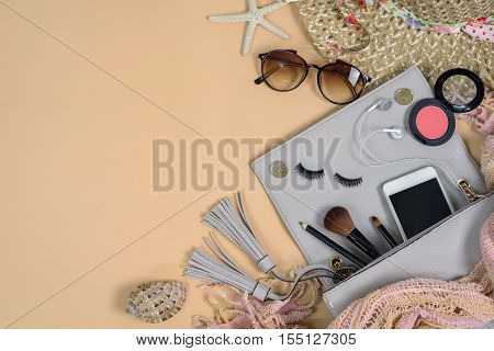 Fashion woman essentials cosmetics cellphone makeup accessories isolated on colorful background Top view