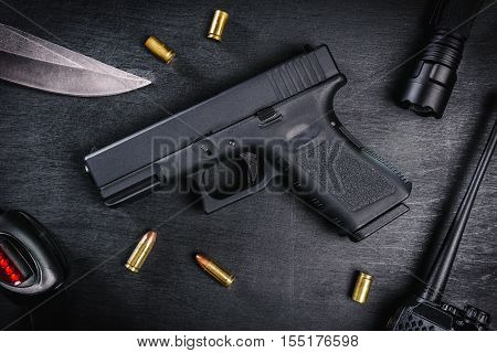 black 9mm pistol on a black wooden table