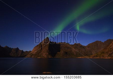 Northern lights over Olstind mountain Lofoten Norway