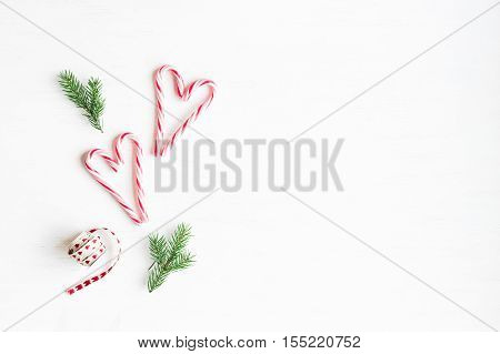 Christmas composition. Christmas candy canes and fir branches. Flat lay top view