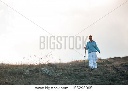 A woman traveling in the mountains, going ahead to the heights.