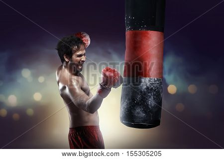 Athletic Asian Boxer Training Uppercut With Punching Bag