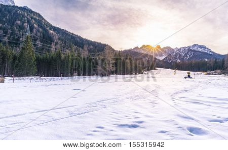 Ski slope in the Alps mountains - Winter scenery with a ski ready to be used in the Austrian Alps mountains on a sunny day of December.
