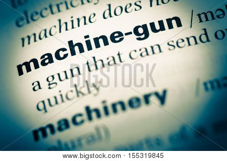 Close Up Of Old English Dictionary Page With Word Machine Gun