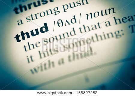 Close Up Of Old English Dictionary Page With Word Thud