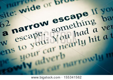 Close Up Of Old English Dictionary Page With Word A Narrow Escape