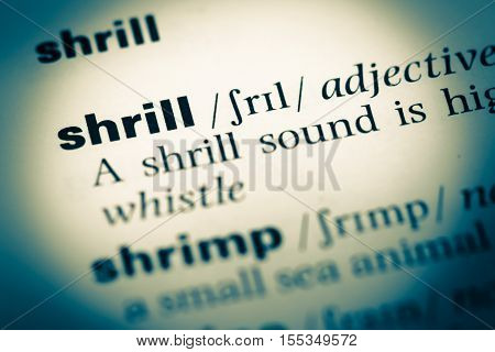 Close Up Of Old English Dictionary Page With Word Shrill