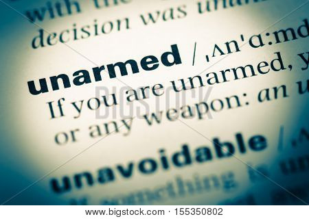 Close Up Of Old English Dictionary Page With Word Unarmed