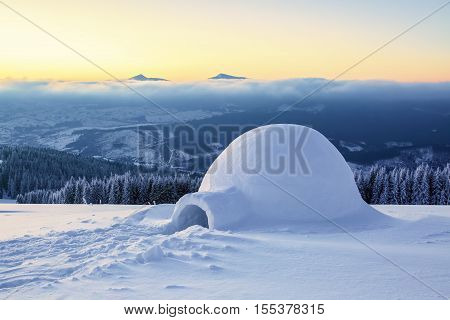 Marvelous huge white snowy hut igloo the house of isolated tourist is standing on high mountain far away from the human eye