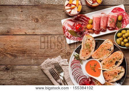spanish tapas and sangria on wooden table, top view ith copy space