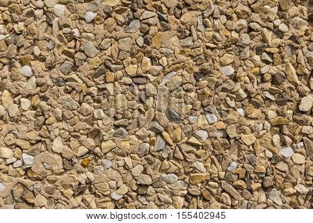 detail of wallcovering with small pieces of different stones texture stone wall