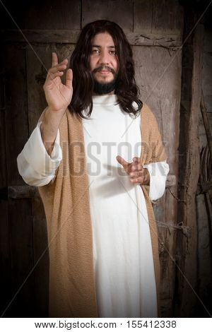 Portrait of a model in the role of Jesus Christ praying or preaching