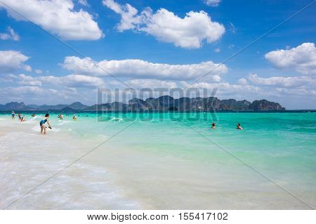 CRABI PROVINCE THAILAND - FEBRUARY 02 2015: Tourists swimming in turquoise water of Andaman sea at Krabi province Thailand