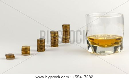 Glass Of Alcohol Drink With Piles Of Coins