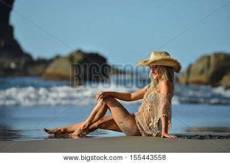 young woman relaxing on the beach in summer day
