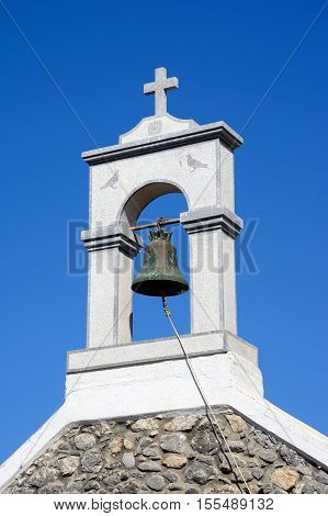 A small bell tower on top of the church in the village centre Milatos Crete Europe.
