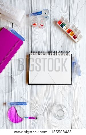 medical student working place with blank open notebook at wooden table top view
