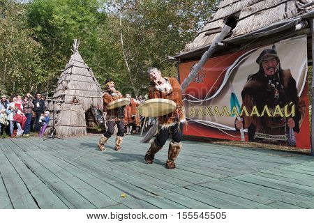 KAMCHATKA REGION RUSSIA - SEP 14 2013: Public concert on Itelmen national holiday of thanksgiving nature Alhalalalay. Expression performance of Ethnic Dance Folk Ensemble Lach with tambourines in clothing aborigine of Kamchatka Peninsula.