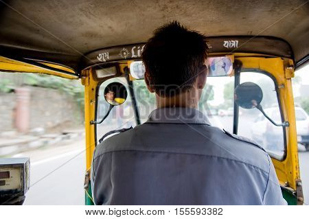 Delhi India - July 22 2011: View from the inside of an auto-rickshaw. Motorized rickshaw common form of public transport in India