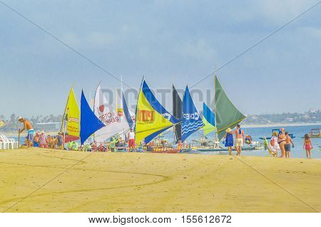 PORTO GALINHAS, BRAZIL, JANUARY - 2016 - Lots of sailing boats at tropical beach in Porto Galinhas Pernambuco Brazil