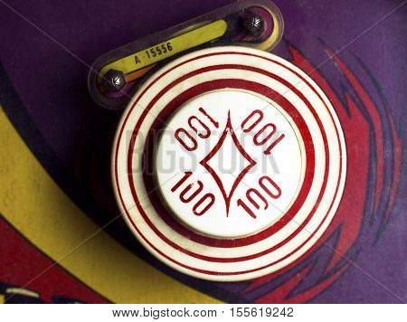Overhead of 100-point bumper on retro pinball machine