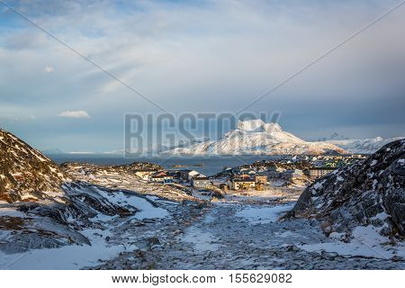 Daylight view to the distant suburb of Nuuk Sermitsiaq mountain in the background