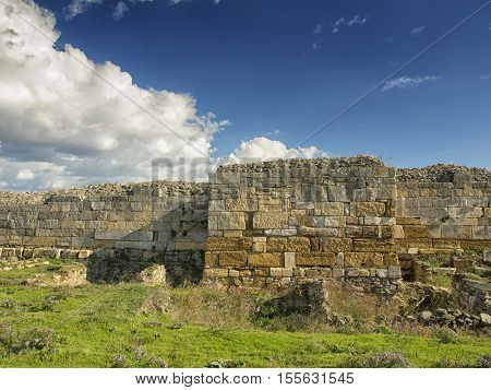 A dramatic blue sky with white clouds over the ruins of the ancient greek colony of Histria, on the shores of Black Sea. Histria is the oldest urban settlement on Romanian territory