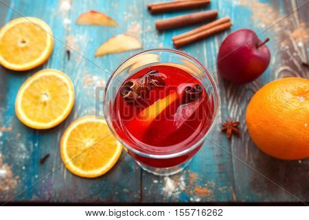 Orange, apple, cinnamom, anice, wine (mulled wine) on wooden background