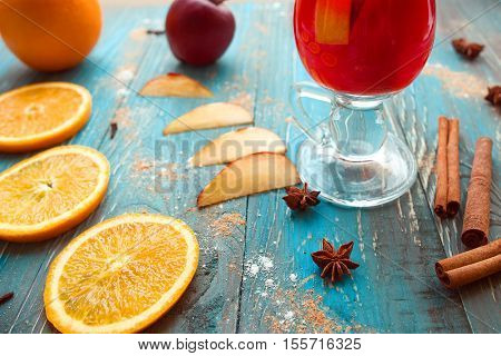 Orange, apple, cinnamom, anice, wine (mulled wine) on wooden background