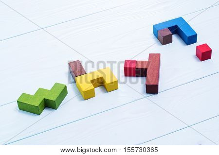 The word why and question mark made from colored wooden puzzles.