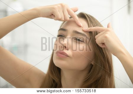 Young Woman Troubled Checking Wrinkles On Her Forehead