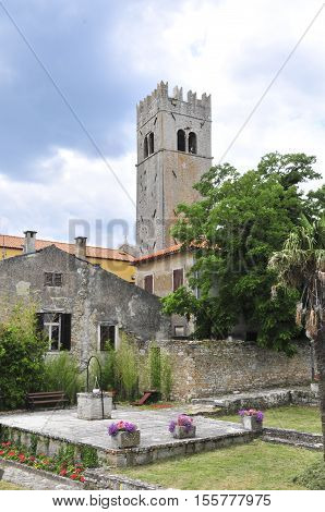 Medieval istrian town of Motovun Croatia shot from the castles garden showing the tower a well and ancient houses.