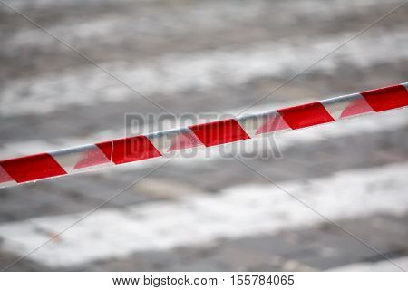 Fencing red and white ribbon which prohibits movement. Danger