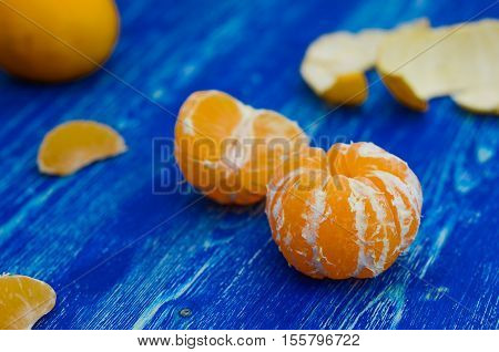 Tangerines on a blue wooden board, picture with space for text or logo