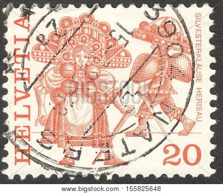 MOSCOW RUSSIA - CIRCA OCTOBER 2016: a stamp printed in SWITZERLAND shows traditional customs the series 