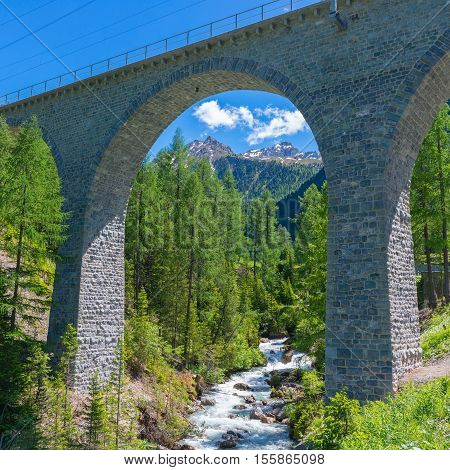 Swiss Alps stone bridge of the Albula Railway. Unesko World Heritage.