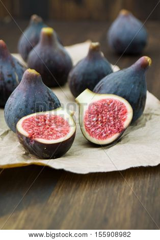 Fresh figs fruits on rustic background. Pile of ripe figs selective focus vertical