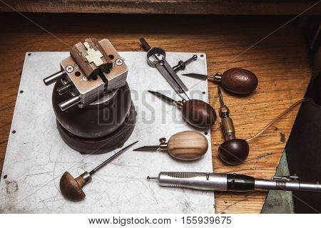 Cross in bullseye vise, gravers, compasses and drilling machine