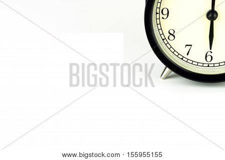 Alarm Clock on white showing six o'clock.