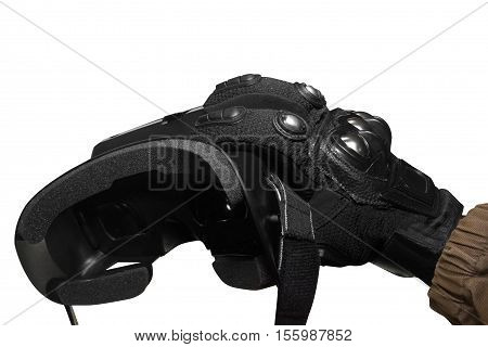 Isolated first person view soldier arm in black battle gloves & tactical jacket holding vr glasses side view.