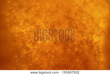 Bubbles floating in the liquid red drink abstract image.