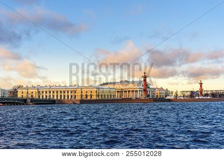 Palace Bridge And Vasilyevsky Island Spit Strelka With Rostral Columns With Fire In Saint Petersburg