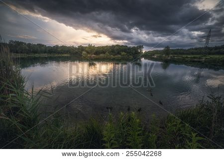 Sunset Over The Lake And Dramatic Sky