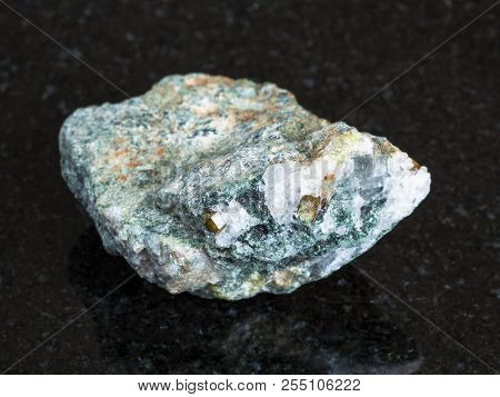 Macro Shooting Of Natural Mineral - Chrysoberyl Crystals In Raw Beryl Rock On Black Granite From Ura