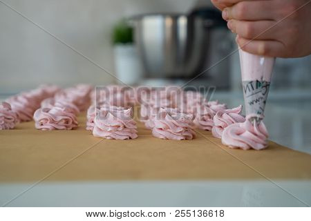 Close Up Hands Of The Chef With Confectionery Bag Cream To Parchment Paper At Pastry Shop Kitchen