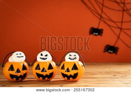 Halloween Crafts, Orange Pumpkin, Ghost And Spide On Wooden Table And Orange Background With Copy Sp